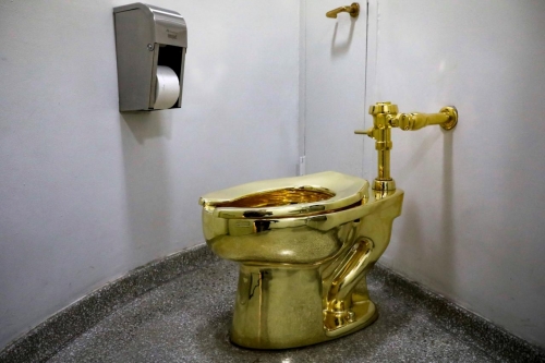 Gold Toilet by Maurizio Catalan